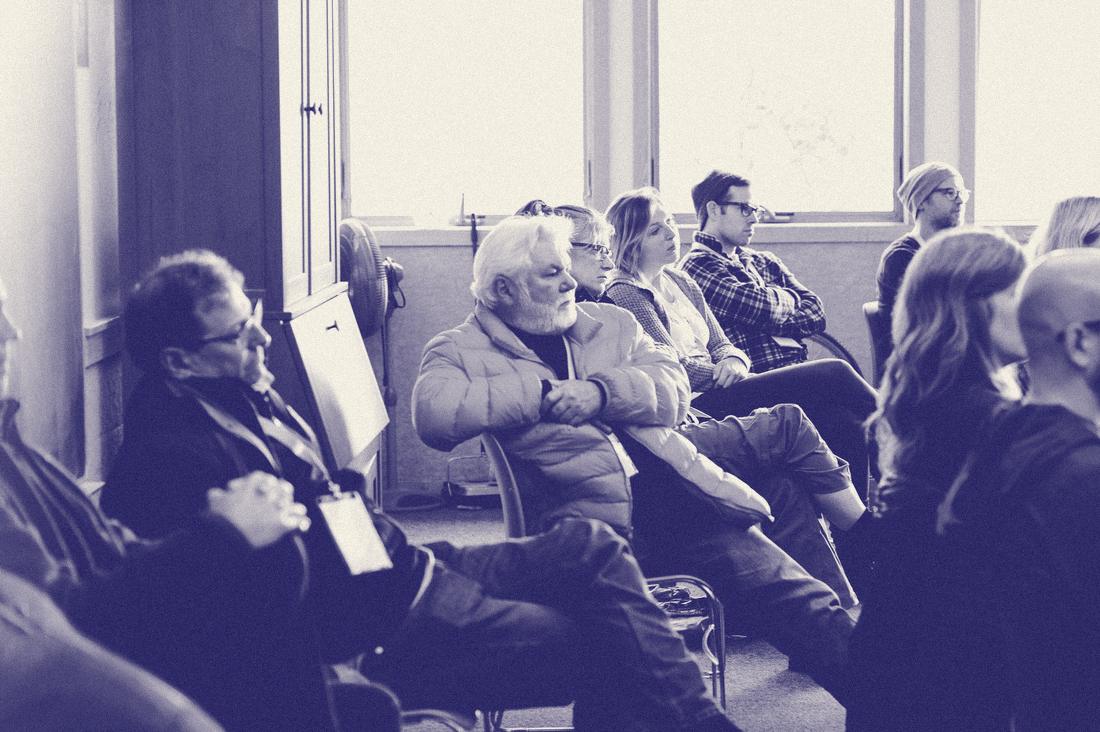 Campers of all ages listening during a session