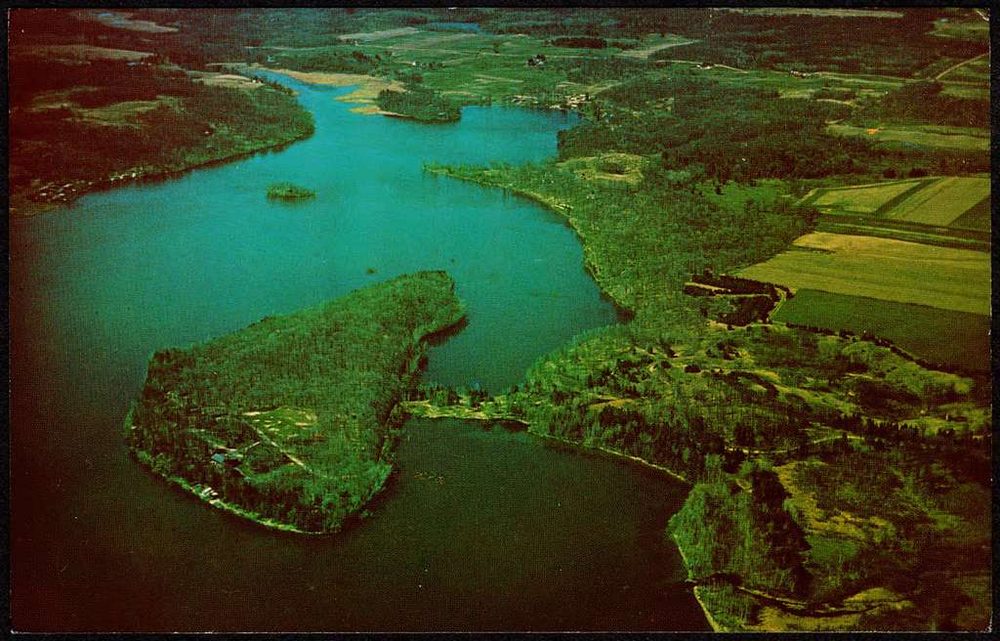 Vintage aerial postcard of the peninsula where Camp Icaghowan sits, surrounded by blue lake water